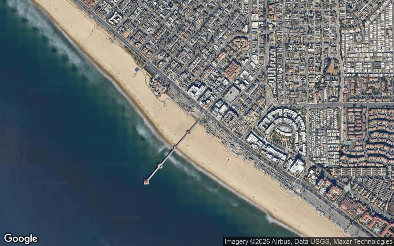 Satellite aerial view of Downtown Pier District in Huntington Beach, California, showing the neighborhood's streets and surroundings.