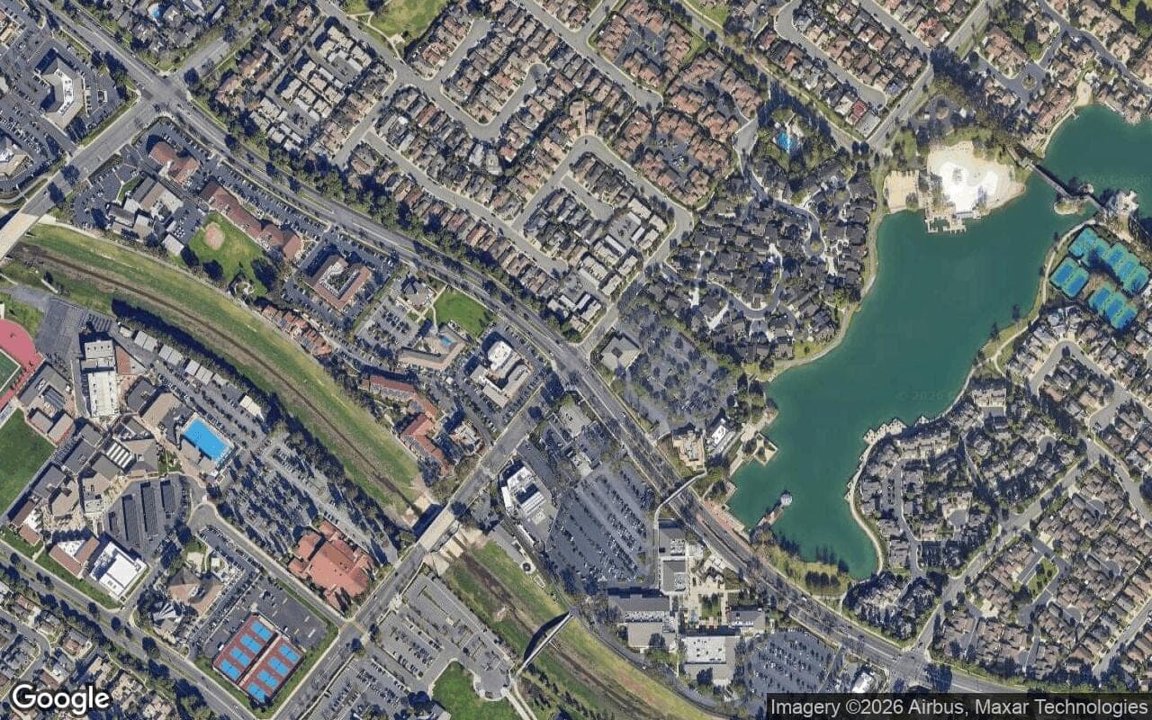 Satellite aerial view of Woodbridge in Irvine, California, showing the neighborhood's streets and surroundings.