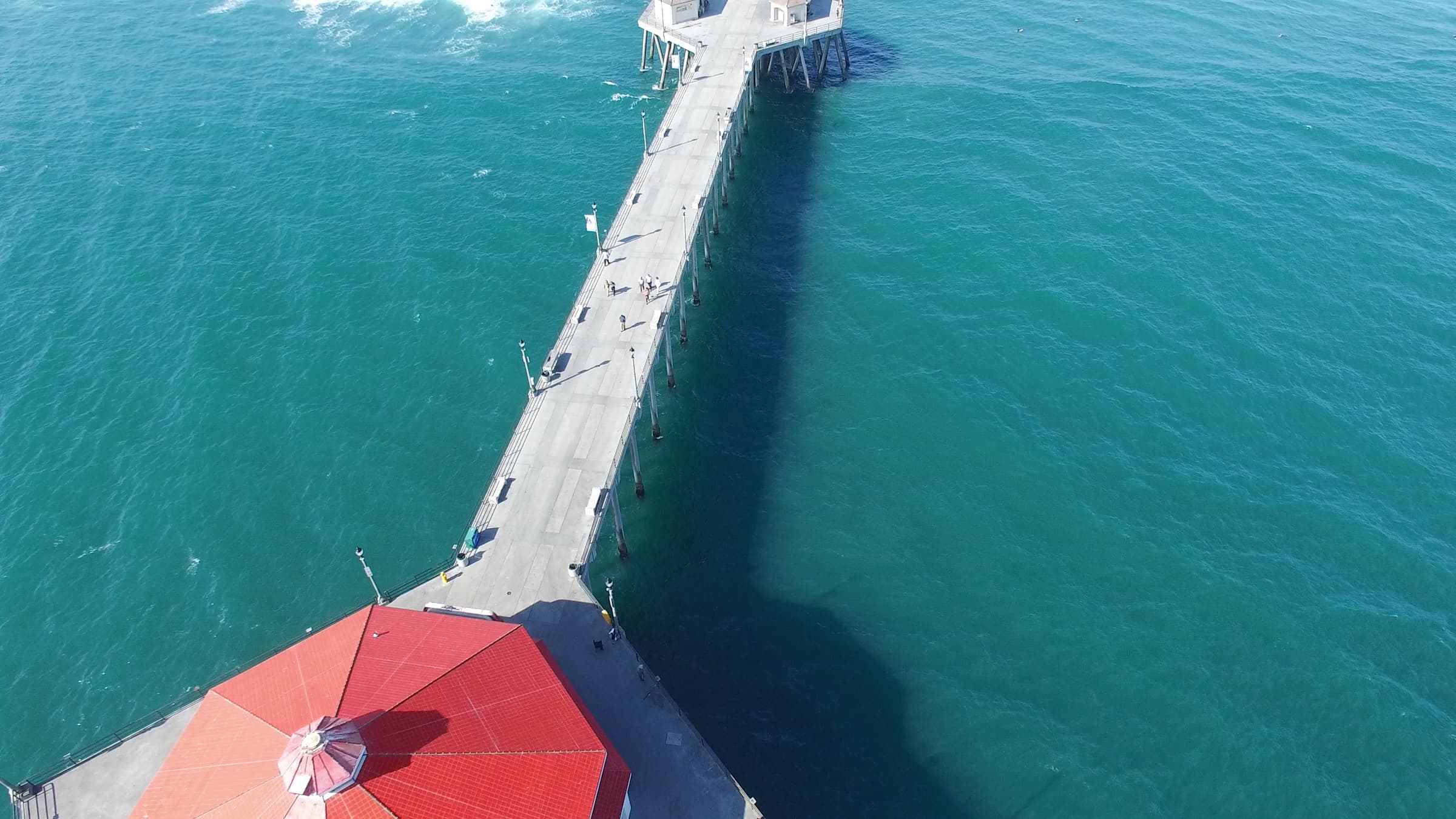Aerial of the Huntington Beach pier and the coastline running south.