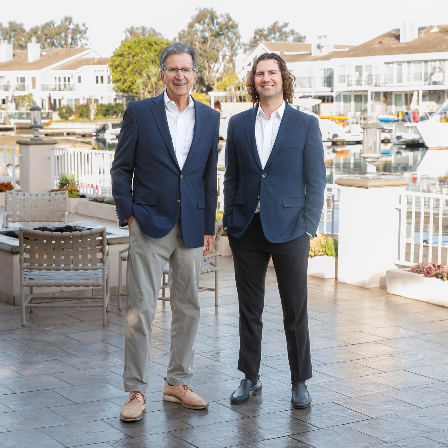 Craig and Justin Ratowsky, Huntington Beach listing agents with Ratowsky Group at Compass, at the Huntington Harbour waterfront.