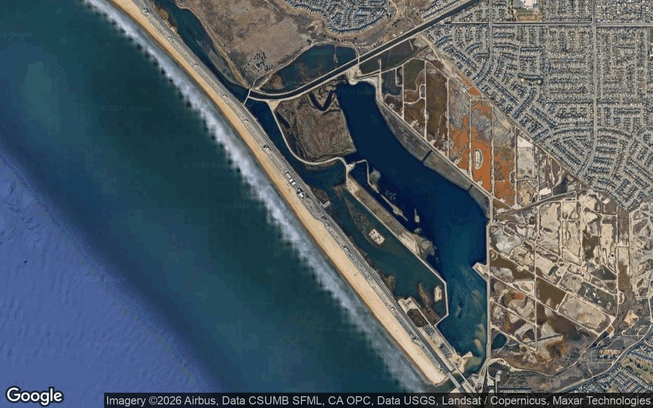 Satellite aerial of the Bolsa Chica wetlands and mesa with the quiet northwest Huntington Beach neighborhoods beyond.