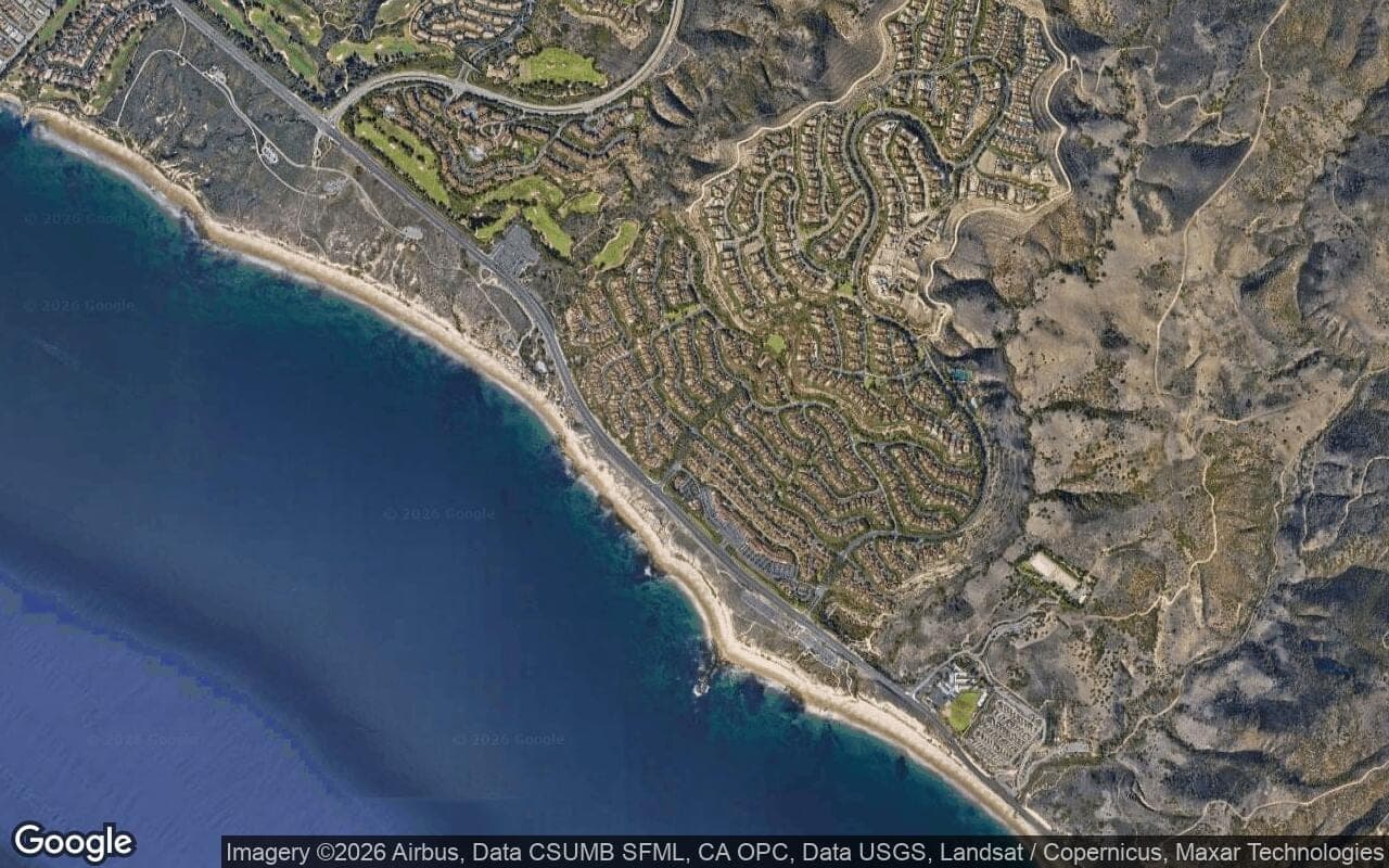 Satellite aerial view of Crystal Cove in Newport Coast, California, showing the neighborhood's streets and surroundings.