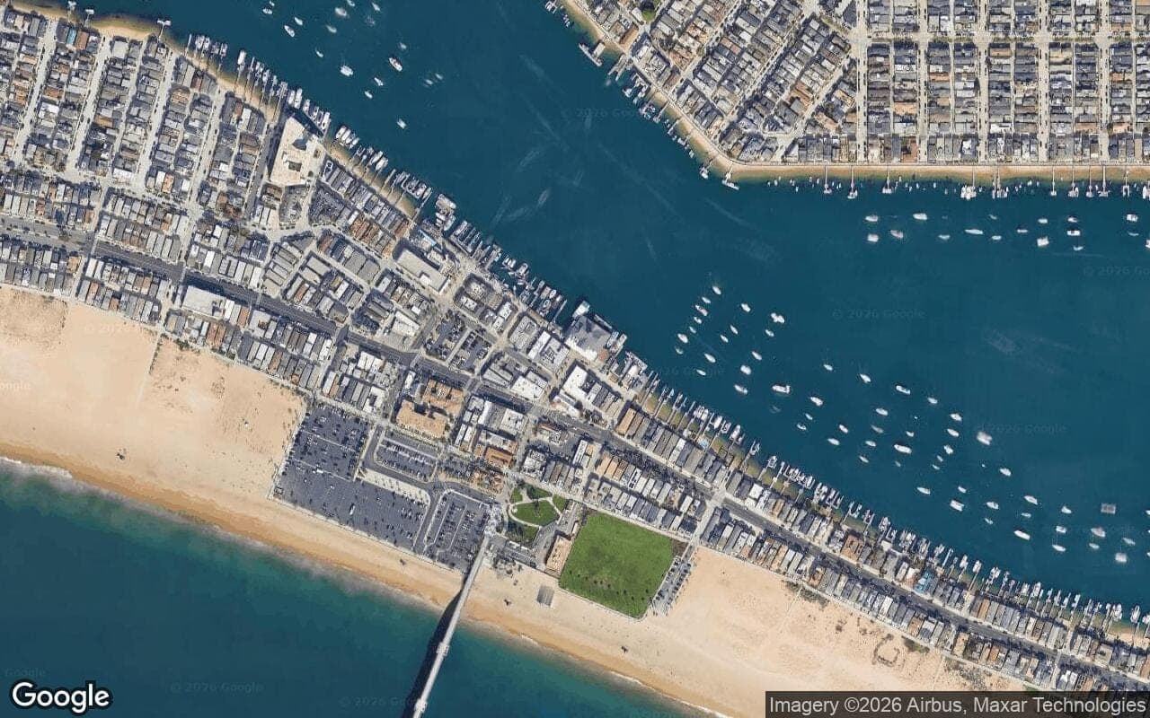 Satellite aerial view of Newport Bay Towers in Newport Beach, California, showing the neighborhood's streets and surroundings.