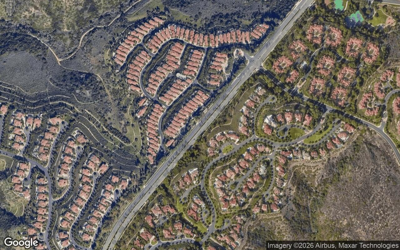 Satellite aerial view of Strada in Newport Coast, California, showing the neighborhood's streets and surroundings.