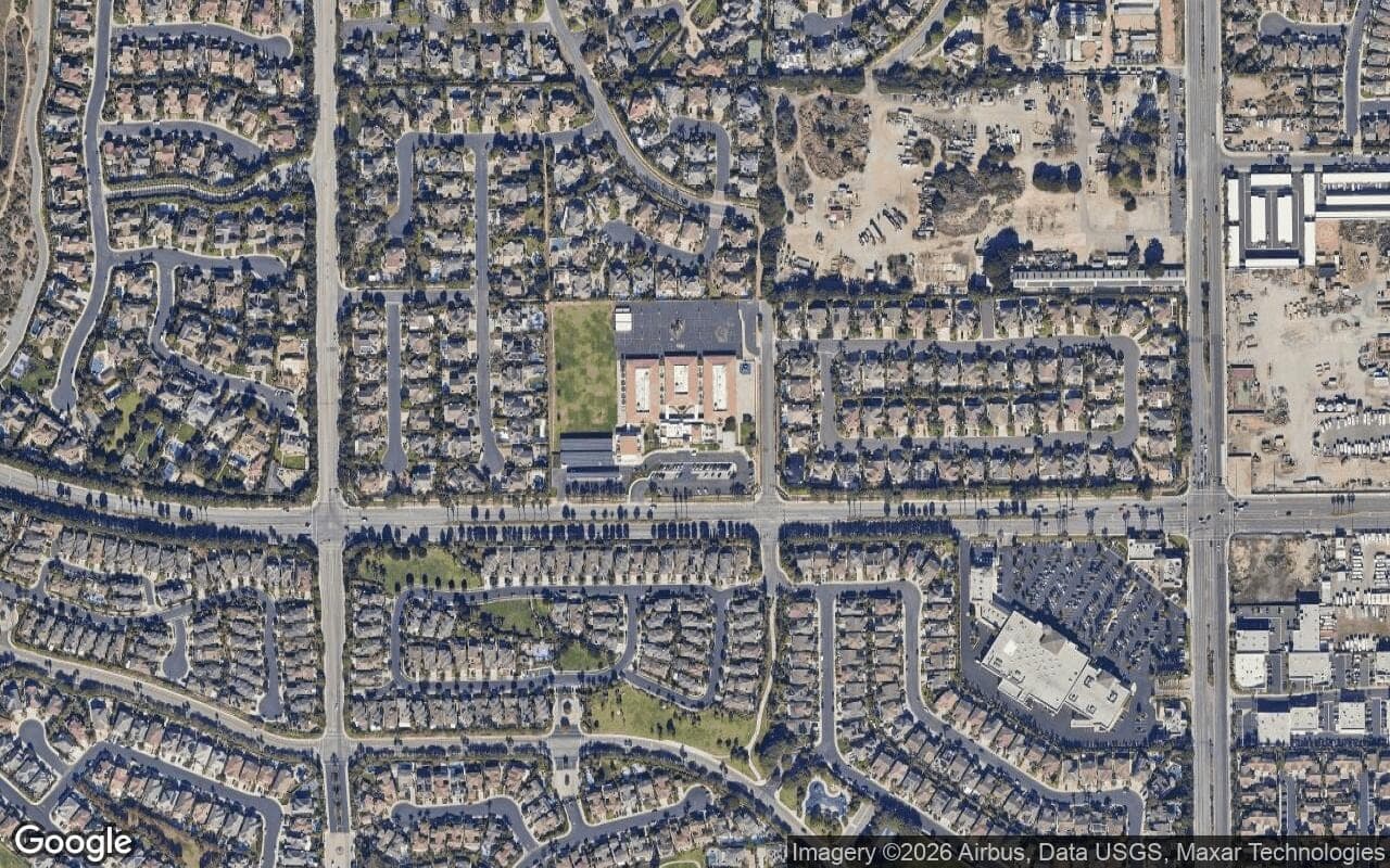 Satellite aerial view of The Hamptons in Huntington Beach, California, showing the neighborhood's streets and surroundings.