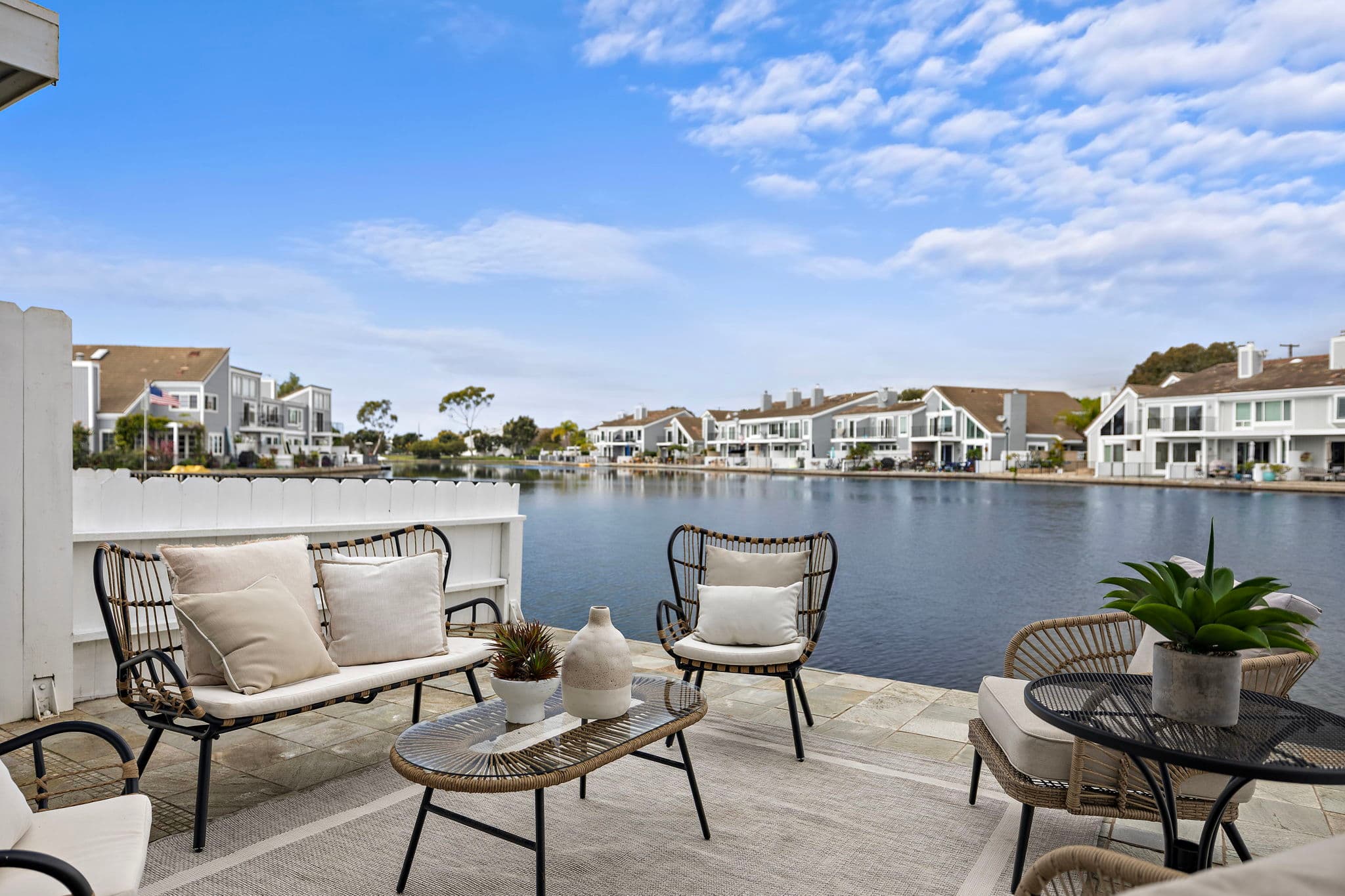 A waterfront patio over a Huntington Harbour channel with the water at the doorstep.