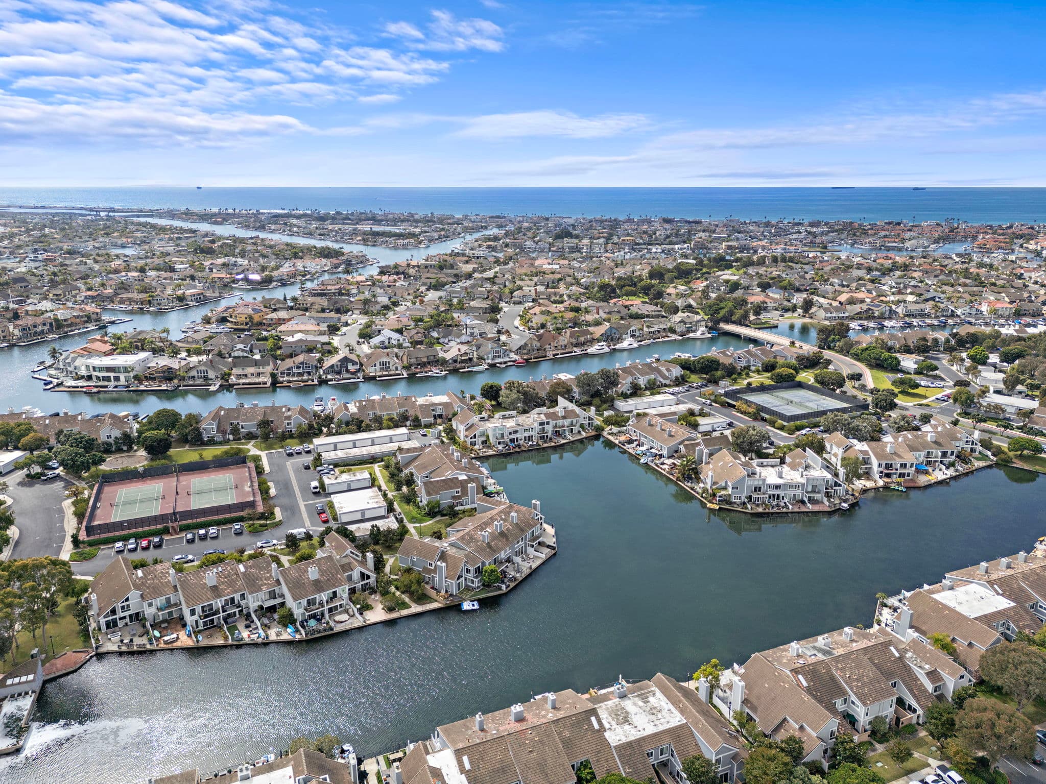 Aerial over the Huntington Harbour islands, waterways, and waterfront homes in Huntington Beach.