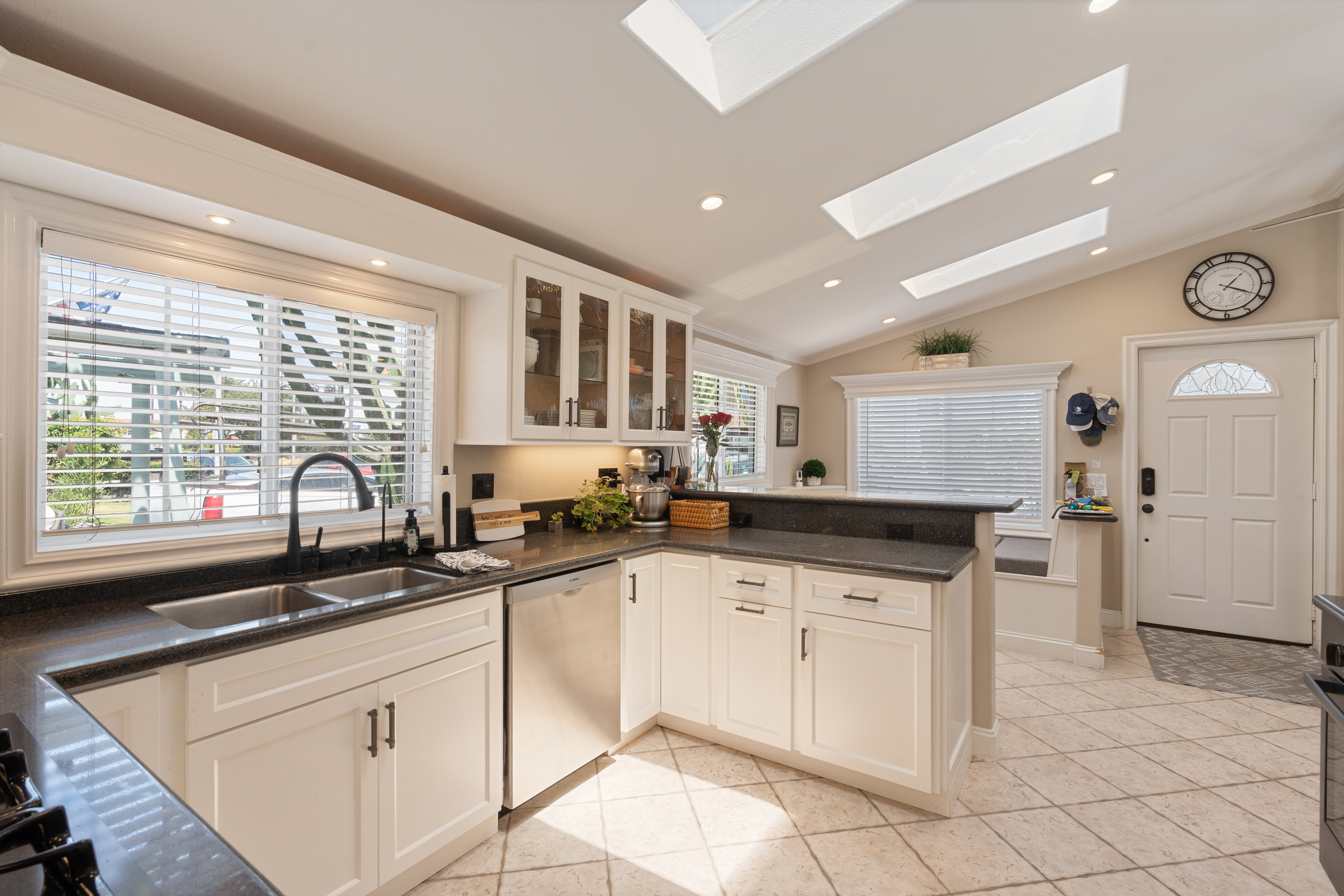 Remodeled open-concept kitchen with skylights and vaulted ceilings in the front residence at 711 Huntington Street.
