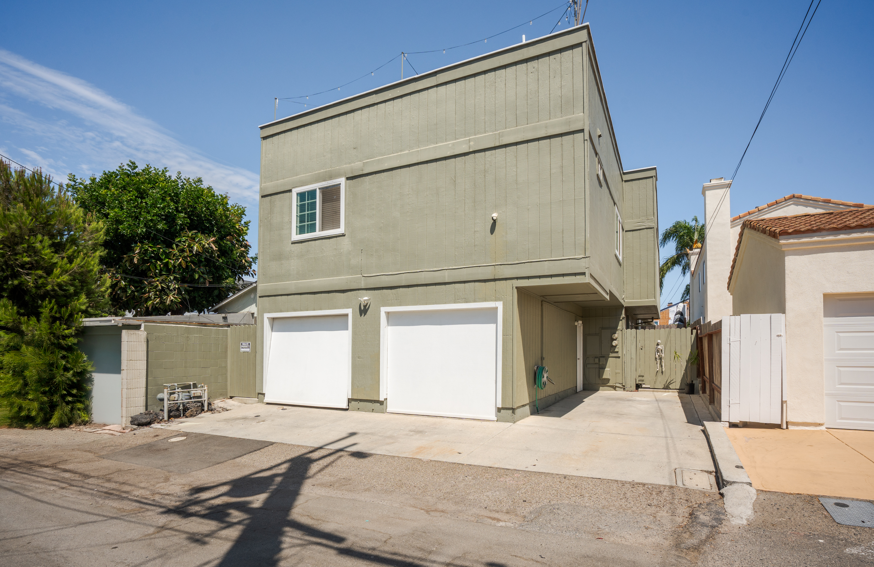 Alley view of the two garage spaces and driveway parking at 711 Huntington Street.