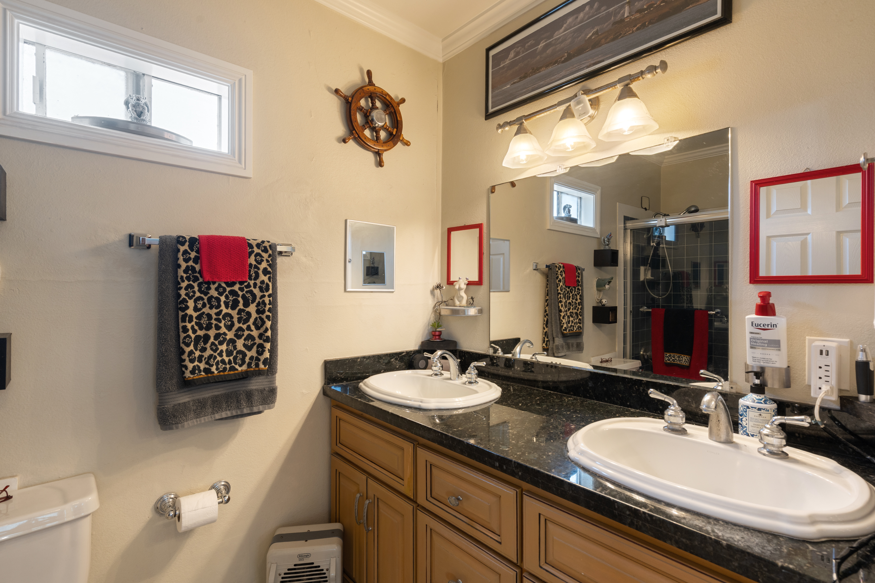 Remodeled dual-sink primary bathroom at 711 Huntington Street.
