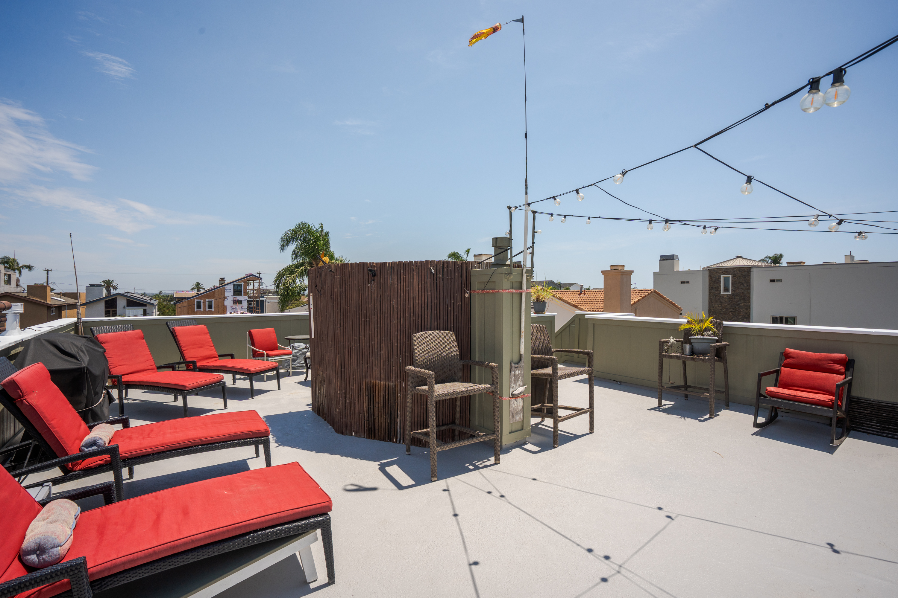 Nearly 1,000-square-foot rooftop deck at 711 Huntington Street with lounge seating and string lights.